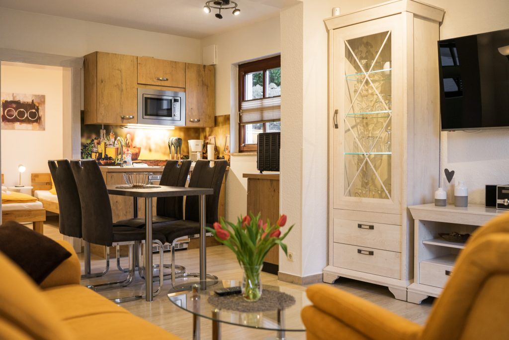 Cozy living room with kitchen and dining table