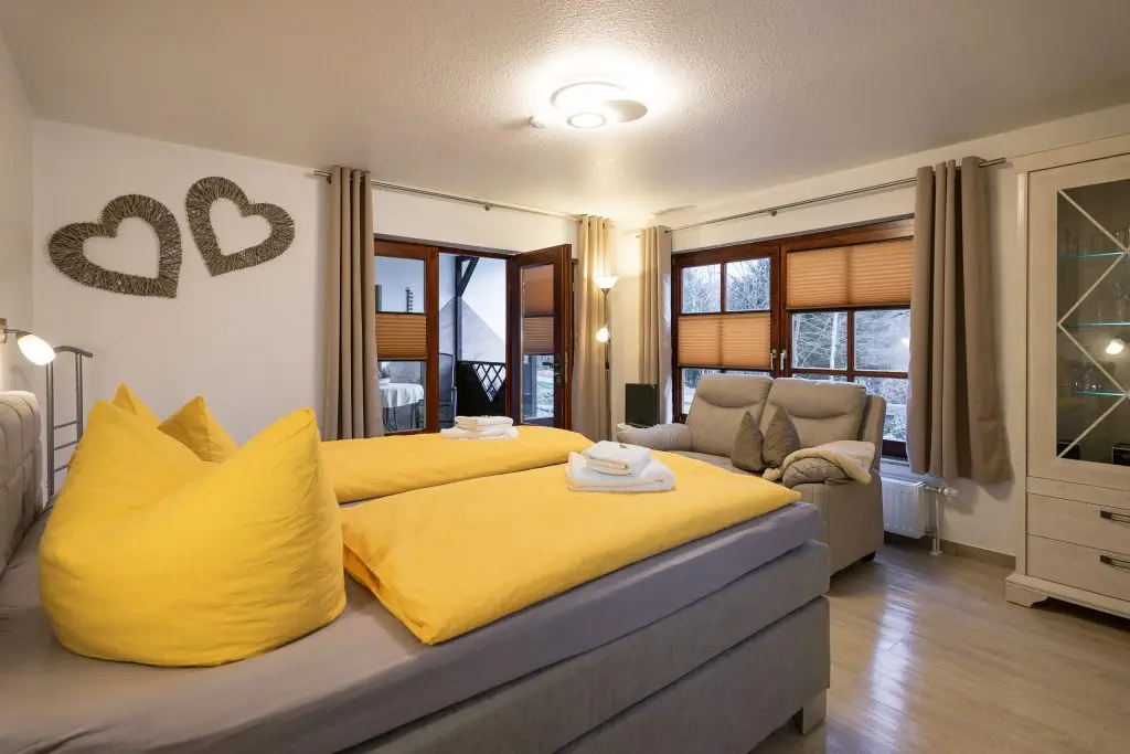Cozy, modern bedroom with a view of the greenery.